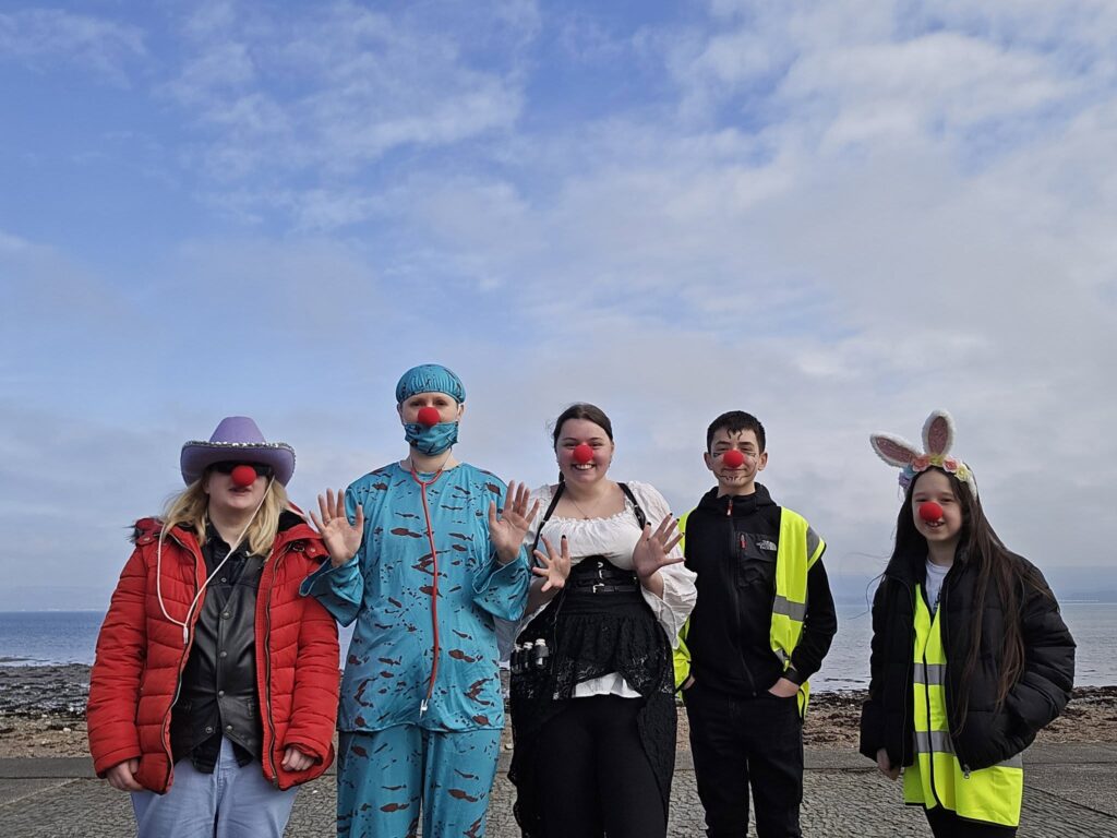 5 volunteers in costumes left to right, female cowgirl, female surgeon, female apothecary, male, female bunny